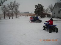 kyle showing kole how to ride the sled and kordel lon the 4 wheeler.jpg