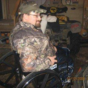 thats me in the garage getting the first look at my totaled sled.  She started back up on the first pull tho dam that was a good sled