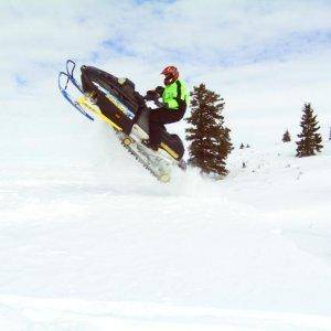 This is my 98 SummitX670 H.O. Rotax sled jumping a small cornise.