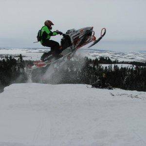 This is a 2003 Polaris 800 my younger brothers sled with me jumping a cornise.