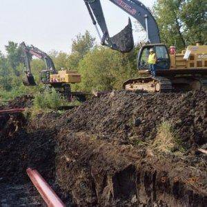 Creek crossing in WI,  42" and a 20" crude oil lines.  two red hoses are two 6" hydrolic water pumps for the flow of the creek across t