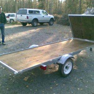 This is a snowmachine deck for my boat trailer. It consists of treated plywood and mild steel angle iron. Ramp becomes road spray guard.