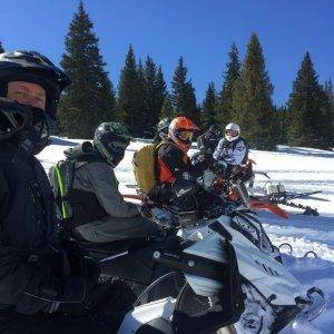 the lone sled with the snowbike gang