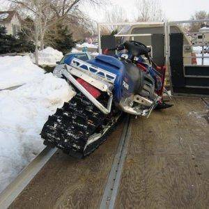 Nate's Sled bashed up at my house on the trailer.