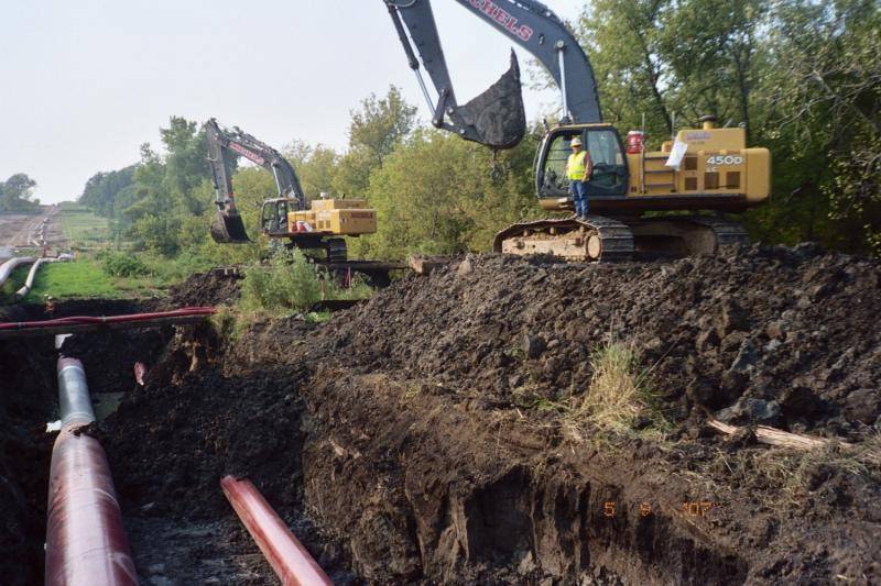 Creek crossing in WI,  42&quot; and a 20&quot; crude oil lines.  two red hoses are two 6&quot; hydrolic water pumps for the flow of the creek across t