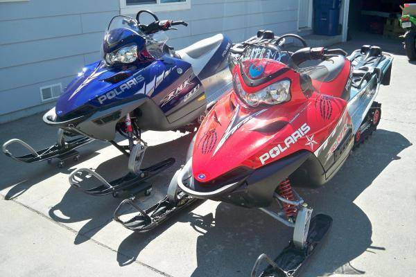 Left is hubby's sled 05' 900 RMK IQ 166&quot; Track 50th anniversay edition; Mine is on the left