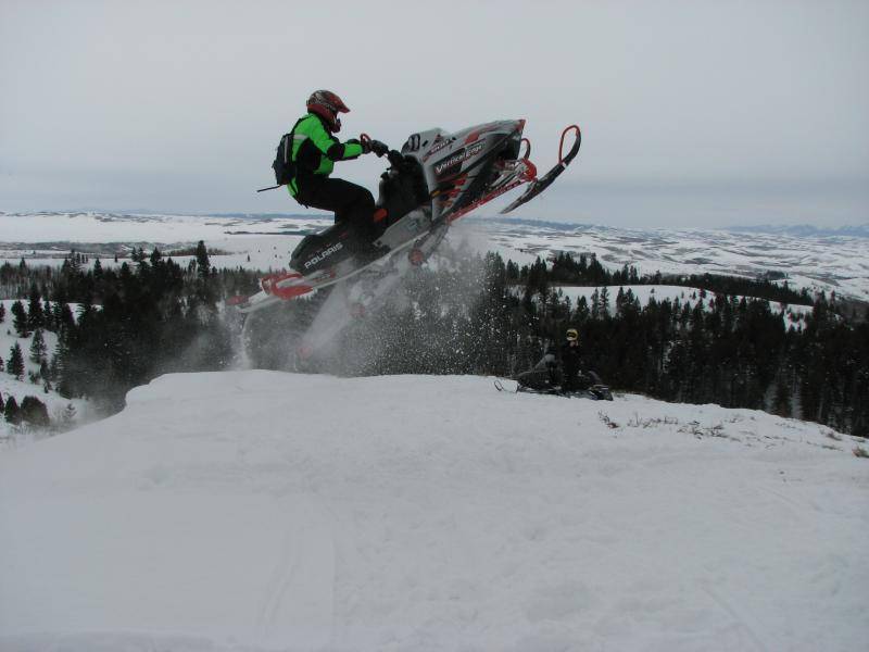 This is a 2003 Polaris 800 my younger brothers sled with me jumping a cornise.