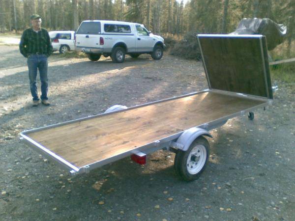 This is a snowmachine deck for my boat trailer. It consists of treated plywood and mild steel angle iron. Ramp becomes road spray guard.