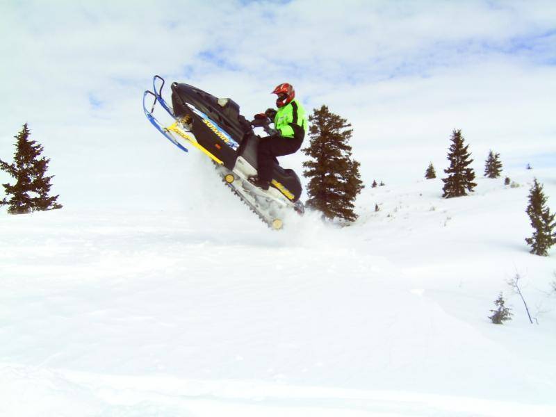 This is my 98 SummitX670 H.O. Rotax sled jumping a small cornise.